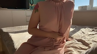A Woman In A Delicate Pink Dress Indulges In Self-Pleasure
